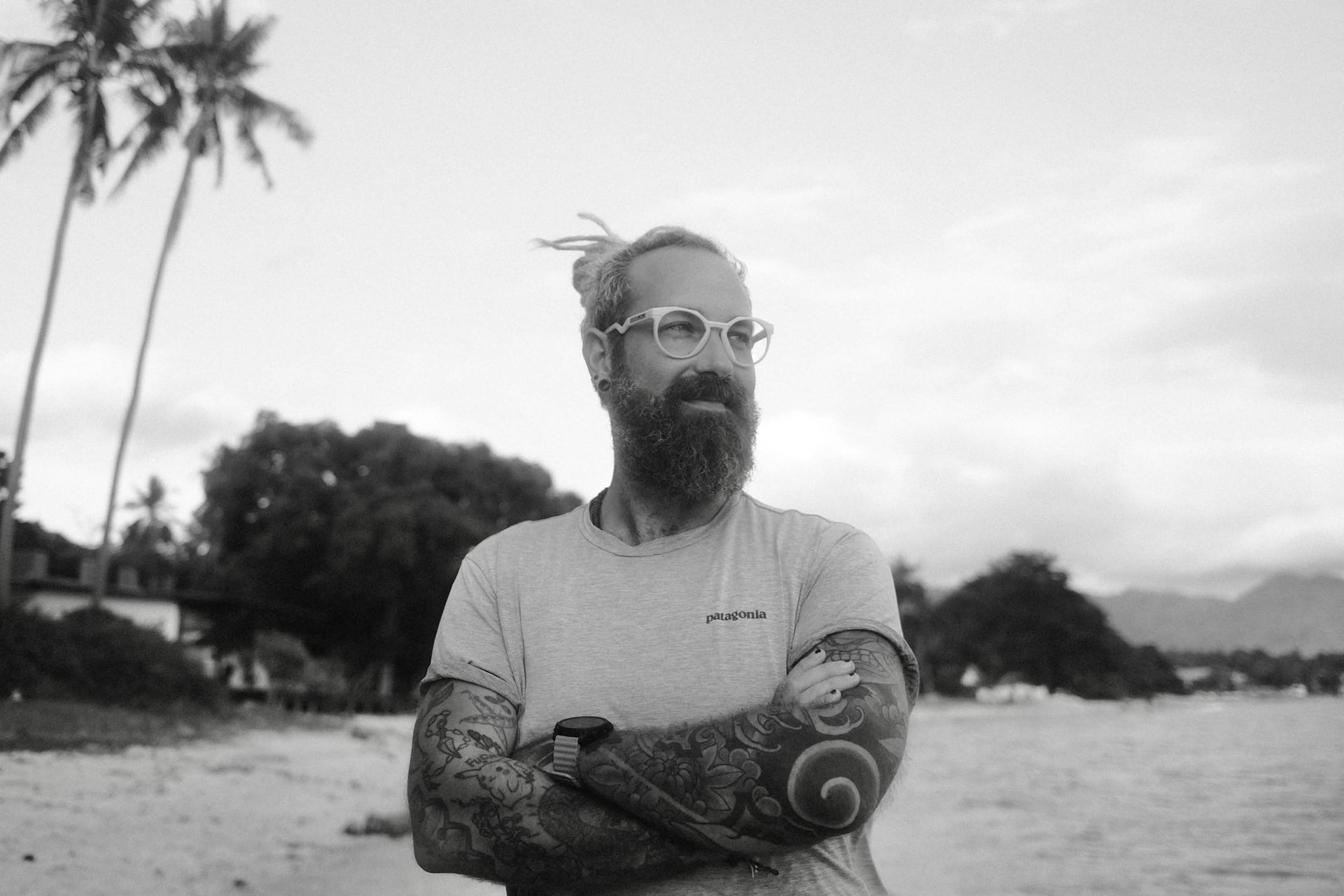 Photo of me, looking in the distance with crossed arms and a smile.